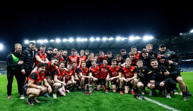 The Down team celebrate with the cup after the game.