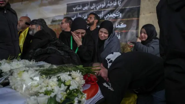 Relatives and friends mourn next to the coffin of Fatima Ftouni, during the funeral of Lebanese journalists, Al Manar reporter Ali Shaib, Al Mayadeen reporter Fatima Ftouni and cameraman Mohammed Ftouni who were killed by a targeted Israeli strike, amid escalating hostilities between Israel and Hezbollah, as the U.S.-Israeli conflict with Iran continues, in Choueifat, Lebanon, March 29, 2026