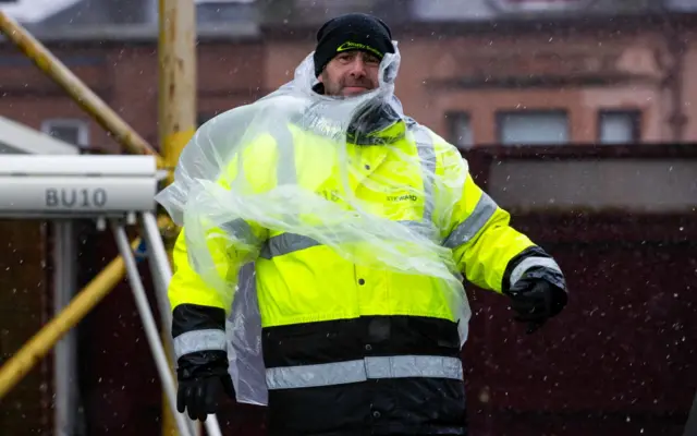 Steward shelters from weather