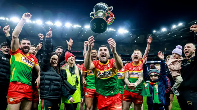 Carlow players celebrate with the Division Four trophy