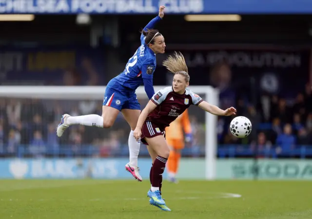 Bronze and Hanson battle for the ball in the air