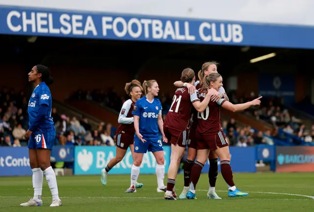 Hanson is mobbed after scoring again v Chelsea