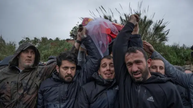 Relatives and friends carry the coffin of Mohammed Ftouni, during the funeral of three Lebanese journalists killed in an Israeli strike