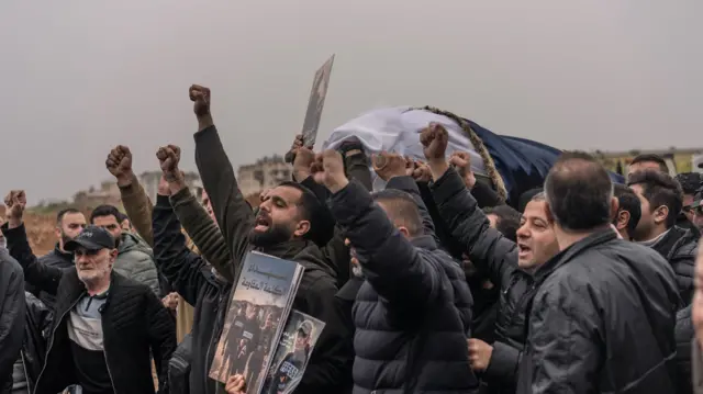 Relatives and friends carry the coffin of Ali Shaib, during the funeral of three Lebanese journalists killed in an Israeli strike