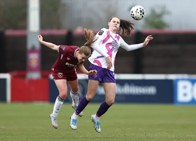 West Ham and London City Lioness players battle for the ball