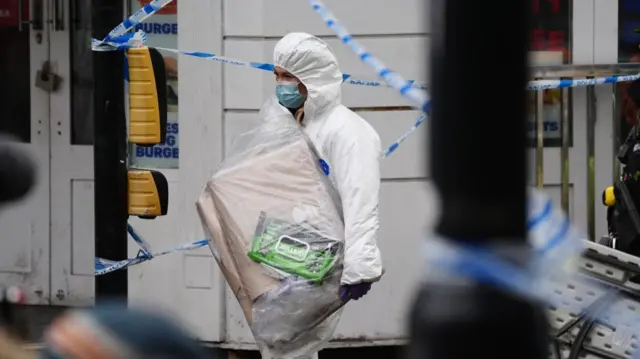 Forensic officer with packages