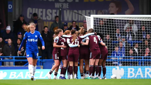 Hanson is mobbed after equalising for Villa