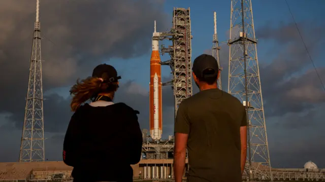 People look at Nasa's next-generation moon rocket, the Space Launch System (SLS) rocket with the Orion crew capsule, on Pad 39B ahead of the Artemis II mission launch at the Kennedy Space Center