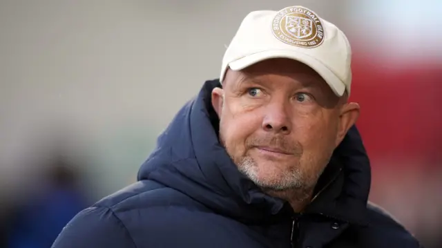 Bromley boss Andy Woodman wearing a baseball cap