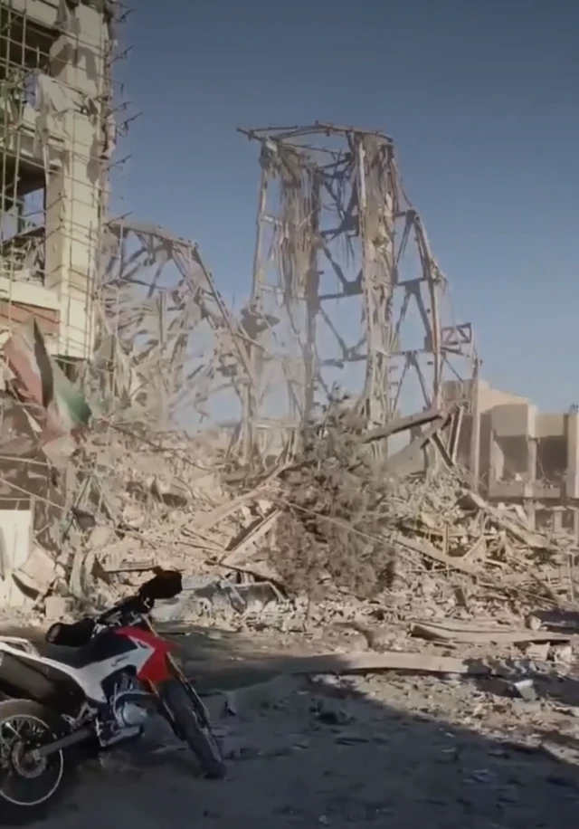 The remains of a building, rubble is strewn everywhere