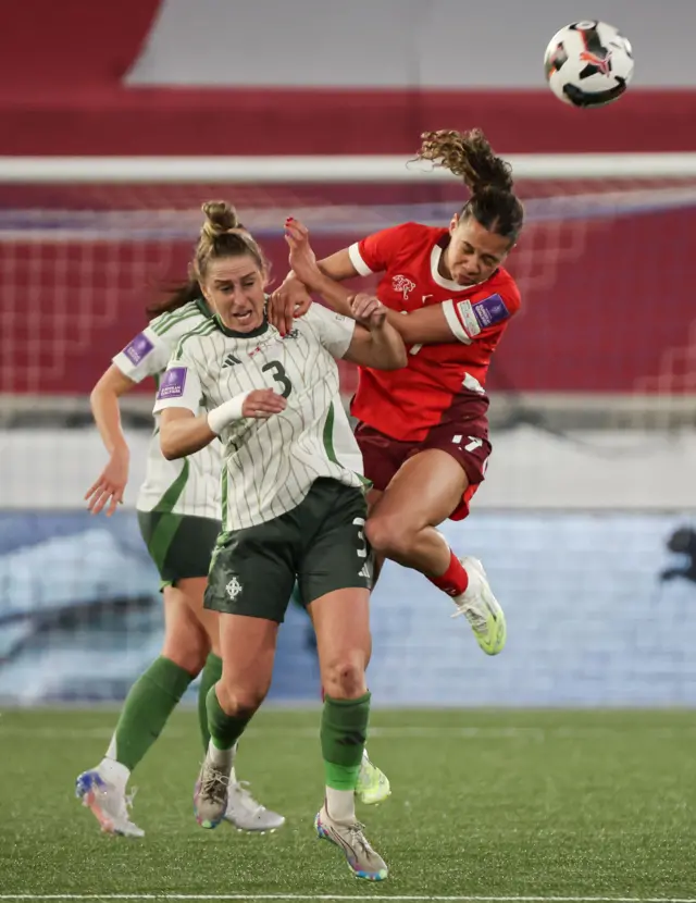 Nat Johnson challenges for the ball