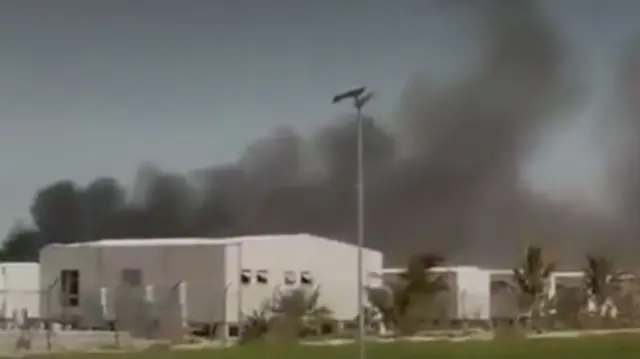 Smoke rises over the port of Duqm in Oman
