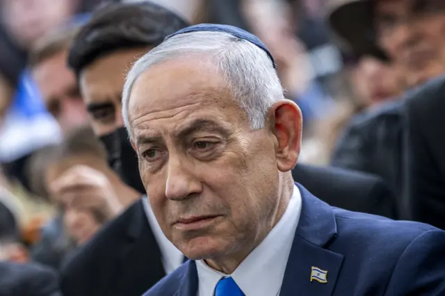 Israel's Prime Minister Benjamin Netanyahu reacts during the funeral of Israeli hostage Ran Gvili