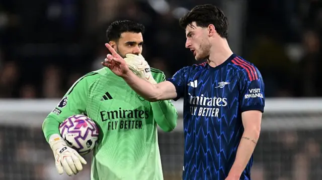 David Raya of Arsenal speaks with teammate Declan Rice