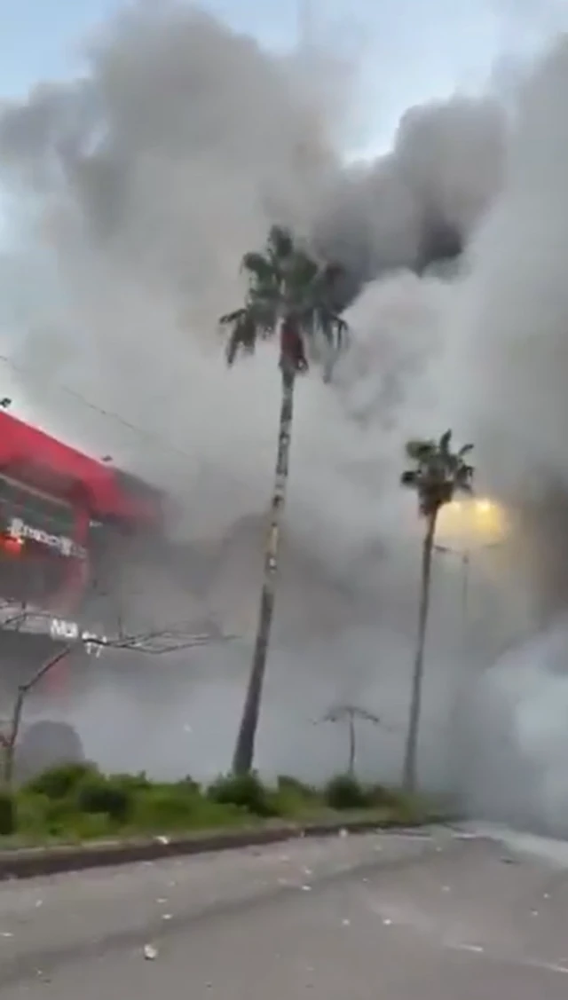 A cloud of smoke obscuring most of a large road