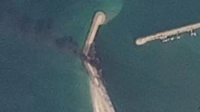 This satellite image of Jask port, taken on 3 March, shows a plume of smoke coming from the jetty in the centre of the picture
