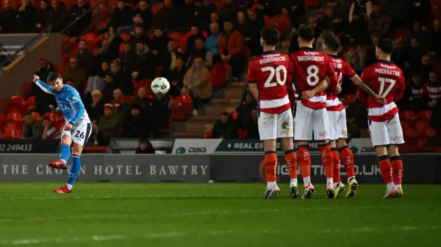 Ollie Norwood curling in the winning free-kick for Stockport at Doncaster