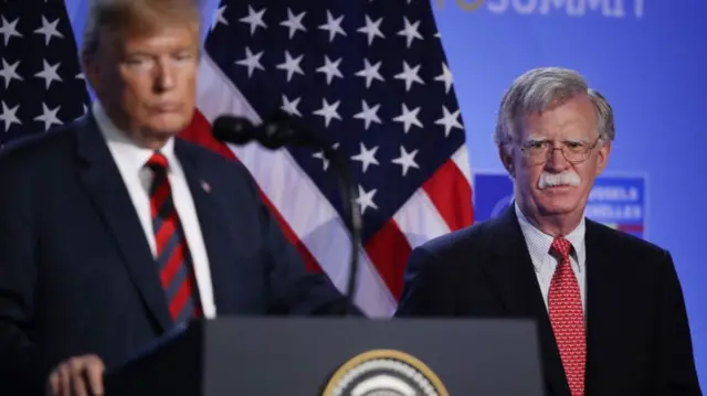 President Donald Trump, flanked by National Security Advisor John Bolton, speaks to the media at a press conference on the second day of the 2018 NATO Summit on July 12, 2018 in Brussels, Belgium