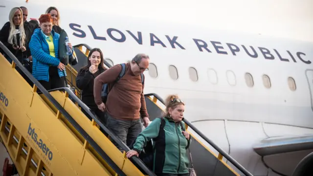 Slovakian passengers head off aircraft down stairs