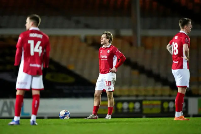 Sam Bell (centre) stands with his arms on his hips with Tomi Horvat to his left and Emil Riis to his right, also with hands on hips
