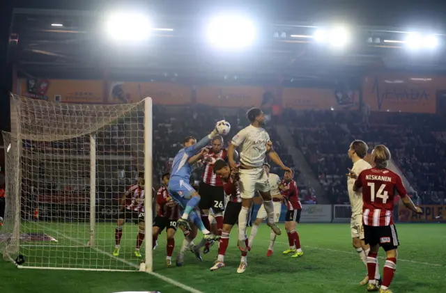 Joe Whitworth of Exeter City punches clear