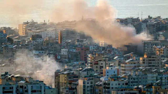 Smoke rises from destroyed buildings