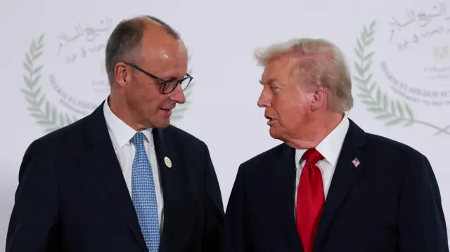 U.S. President Donald Trump and German Chancellor Friedrich Merz talk as they pose for a photo, at a world leaders' summit on ending the Gaza war, amid a U.S.-brokered prisoner-hostage swap and ceasefire deal between Israel and Hamas, in Sharm el-Sheikh, Egypt, October 13, 2025.