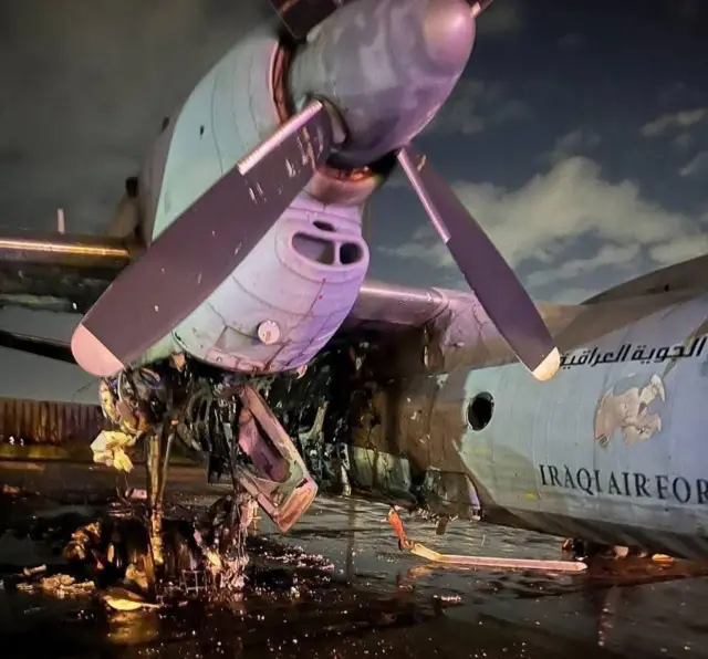 An Iraqi Air Force plane on the tarmac with significant damage