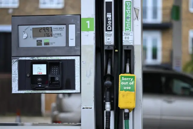 An out-of-use sign hangs from a nozzle of an unleaded petrol pump on the forecourt of an Asda petrol station in Bethnal Green