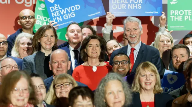 Eluned Morgan and Huw Irranca-Davies in a crowd of supporters
