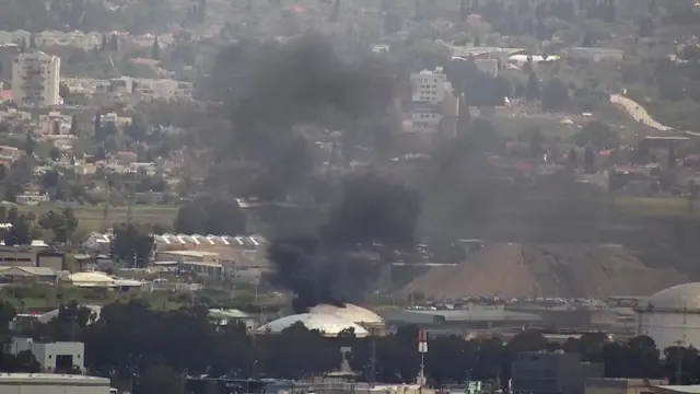 Smoke rising from an oil refinery in Haifa, northern Israel