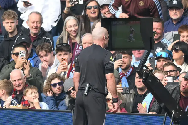 Referee Paul Tierney checks VAR