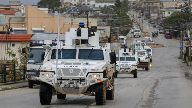 UNIFIL vehicles drive on a main road in Qlayaa, amid escalating hostilities between Israel and Hezbollah
