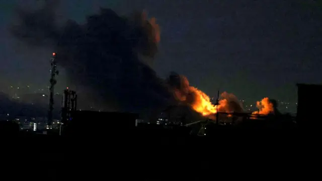 A plume of smoke rises from the site of a strike in Tehran on Sunday