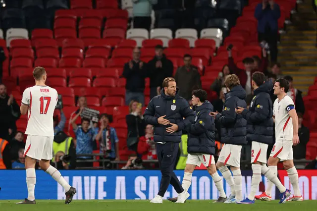 England's striker Harry Kane (C) and teammates applaud a near-empty stadium after the friendly international football match between England and Japan at Wembley Stadium in London on March 31, 2026. Japan won the game 1-0.