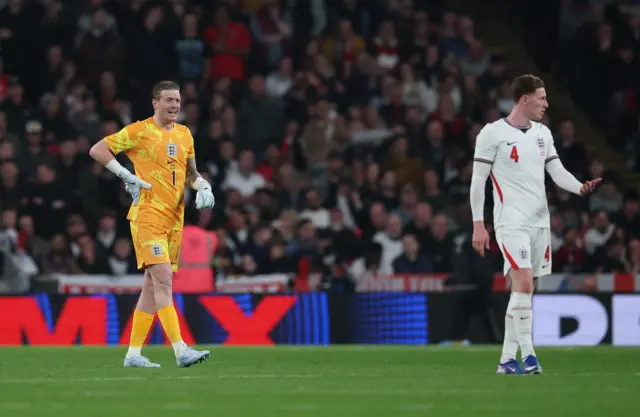 Jordan Pickford of Englands talks with teammate Elliot Anderson after they conceded the first goal