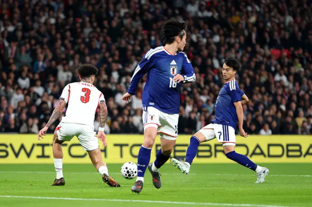 Japan's Kaoru Mitoma (right) celebrates scoring the opening goal during the international friendly match at Wembley Stadium, London.