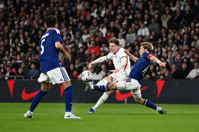Elliot Anderson of England takes a shot as he is challenged by Ritsu Doan of Japan during the international friendly match between England and Japan at Wembley Stadium on March 31, 2026 in London, England.