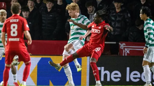 A closer look at the penalty incident as Liam Scales fouls Toyosi Olusanya.
