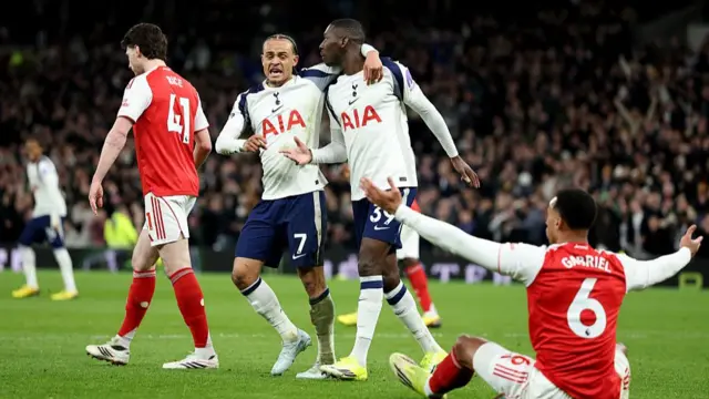 Randal Kolo Muani celebrates as Gabriel protests from the floor