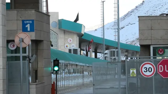 A black flag shown on top of a building flying in the sky