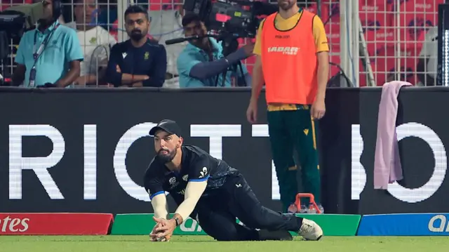 Daryl Mitchell of New Zealand takes the catch to dismiss Aiden Markram of South Africa