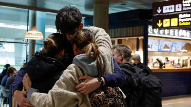 A family hugs in Valencia's arrivals