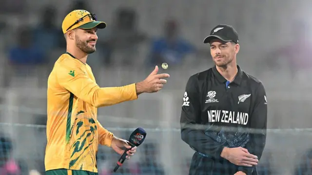 South Africa's captain Aiden Markram and New Zealand's captain Mitchell Santner look on during the toss at the start of the 2026 ICC Men's T20 Cricket World Cup semi-final match between New Zealand and South Africa at the Eden Gardens in Kolkata on March 4, 2026.