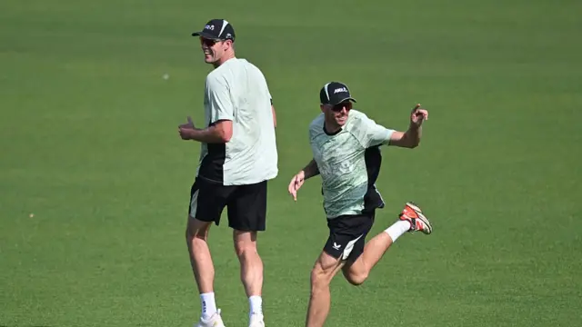 New Zealand's captain Mitchell Santner (R) and Kyle Jamieson (L) attend a training session on the eve of their 2026 ICC Men's T20 Cricket World Cup semi final match aginst South Africa at the Eden Gardens in Kolkata