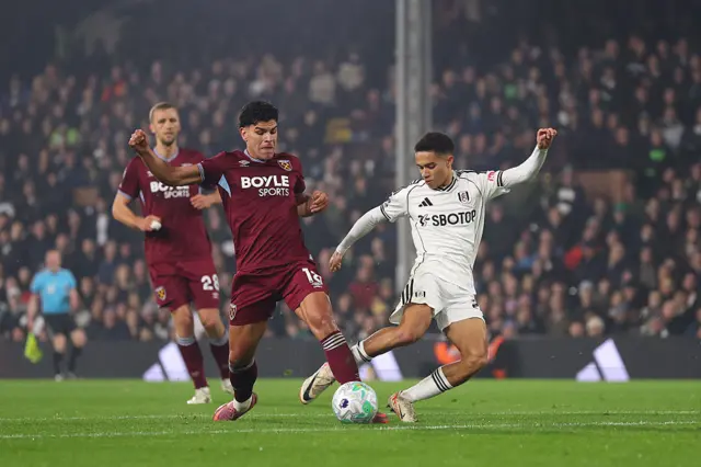 Joshua King of Fulham is challenged by Mateus Fernandes of West Ham United