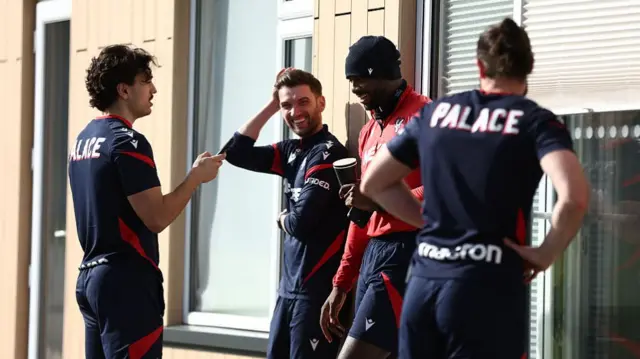 Jean Philippe Mateta relaxes with teammates at the training ground