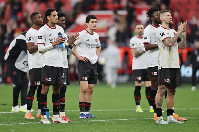 The Bayer Leverksuen squad applaud their supporters