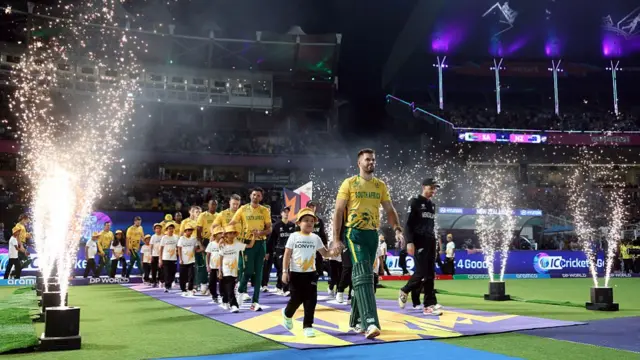 South Africa and New Zealand players make their way out onto the pitch