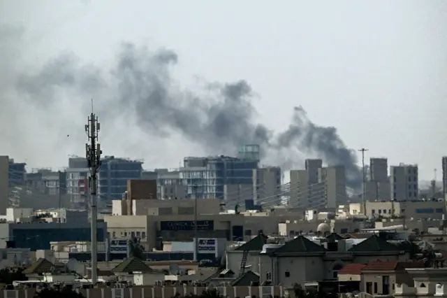 A plume of smoke rises over buildings in Doha